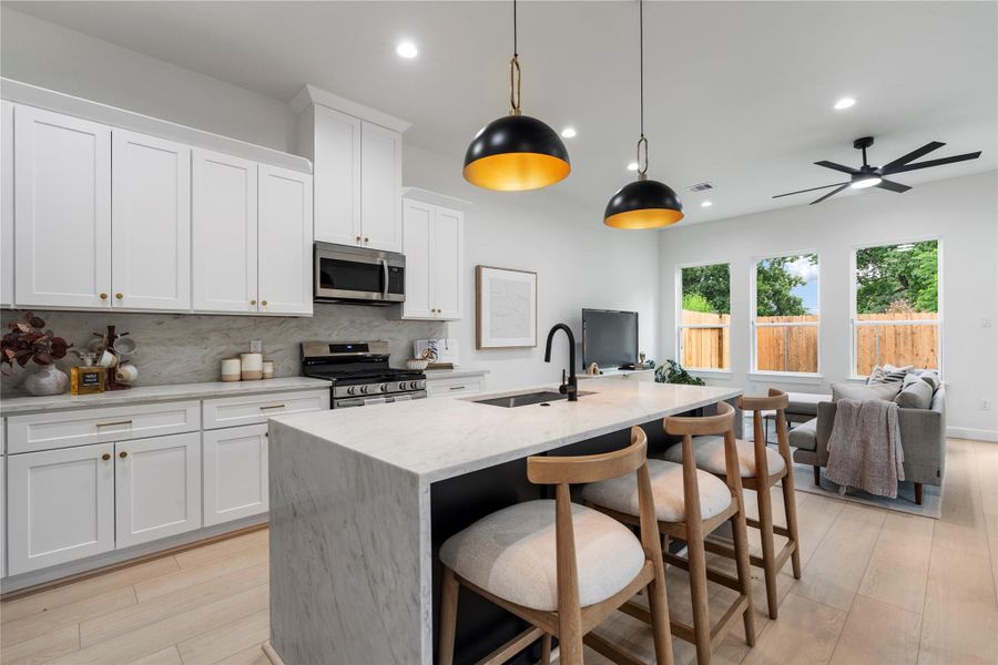 Functional island layout with stainless appliances and quartz counters throughout. Functional island layout with stainless appliances and quartz counters throughout.
