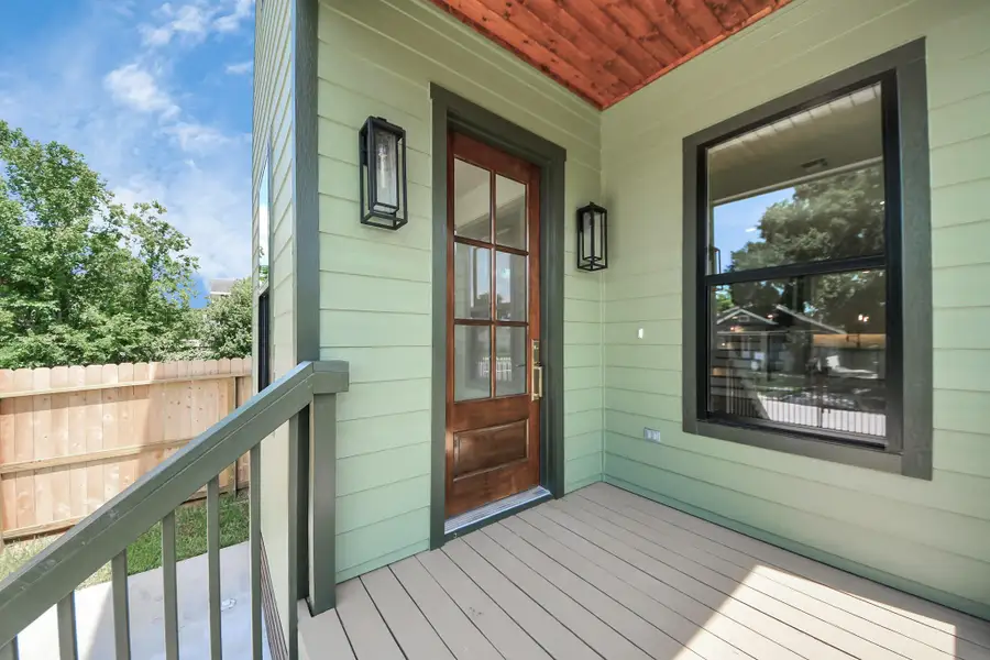 This cozy front patio is the perfect little welcome home. With warm wood accents, soft green siding, and modern lantern lighting, it strikes just the right balance between charm and style. Whether you're sipping morning coffee or waving to neighbors, this spot invites you to slow down and stay a while. This cozy front patio is the perfect little welcome home. With warm wood accents, soft green siding, and modern lantern lighting, it strikes just the right balance between charm and style. Whether you're sipping morning coffee or waving to neighbors, this spot invites you to slow down and stay a while.