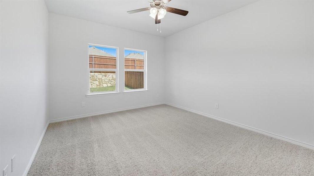 Unfurnished room with light carpet and ceiling fan Unfurnished room with light carpet and ceiling fan