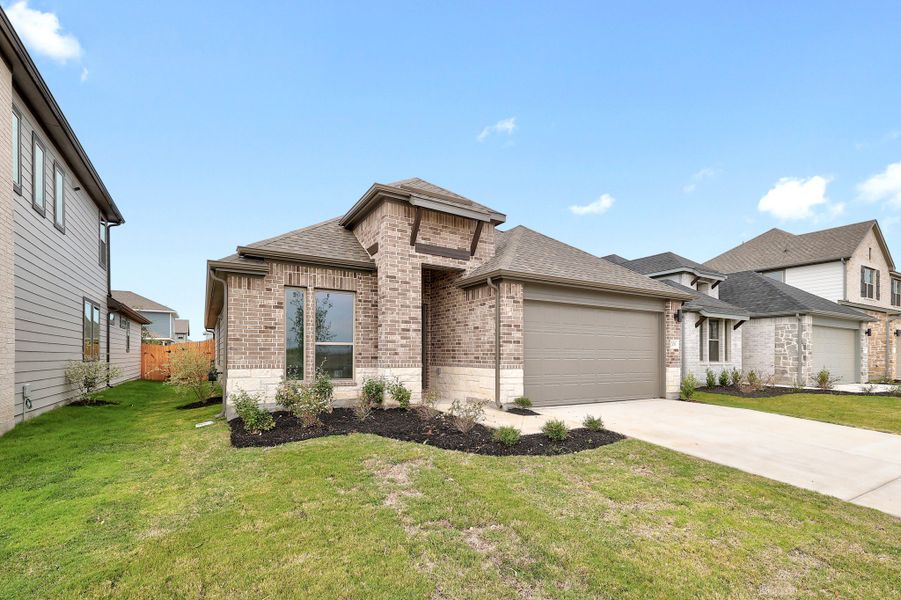Front exterior of a new home in Prairie Winds, Hutto, TX, highlighting curb appeal (Image 2). Front exterior of a new home in Prairie Winds, Hutto, TX, highlighting curb appeal (Image 2).
