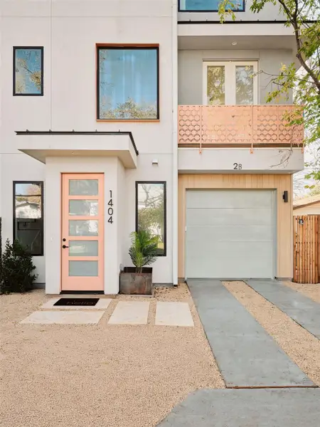 Modern home with an attached garage, stucco siding, and driveway