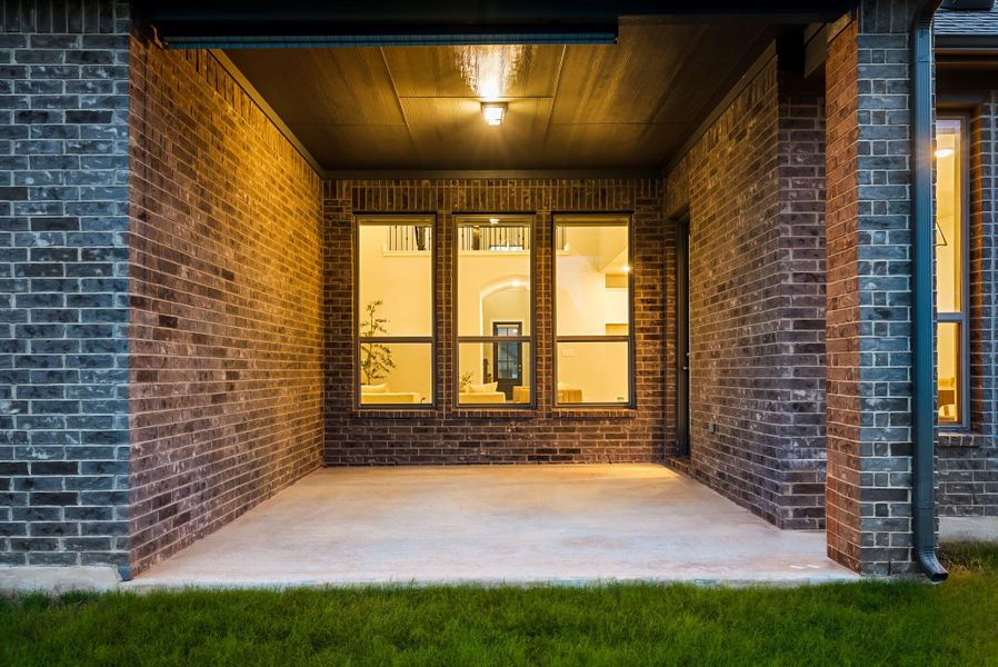 A sheltered concrete patio offers an inviting outdoor retreat.