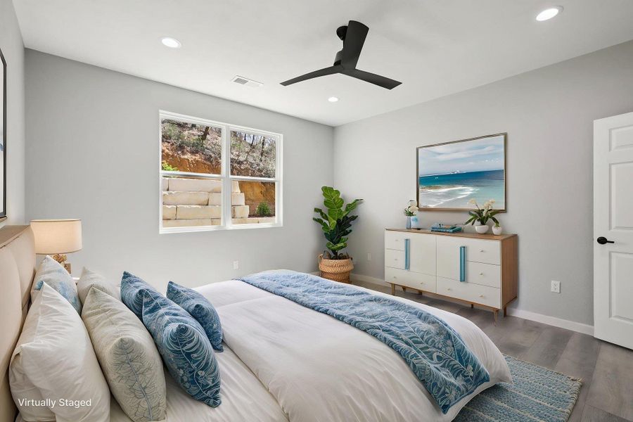 Virtually Staged Primary Bedroom with  light wood-type laminate flooring, ceiling fan, and recessed lighting