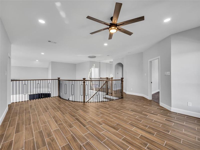 Living room off of stairs with ceiling fan. Living room off of stairs with ceiling fan.