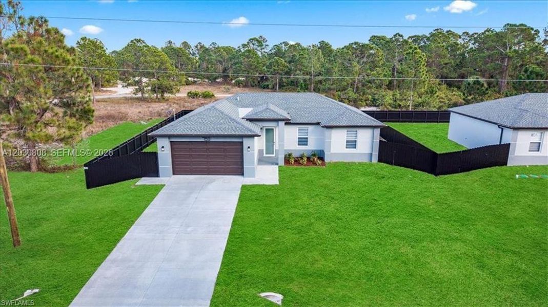 Front exterior of a new home in , Lehigh Acres, FL, highlighting curb appeal (Image 23).