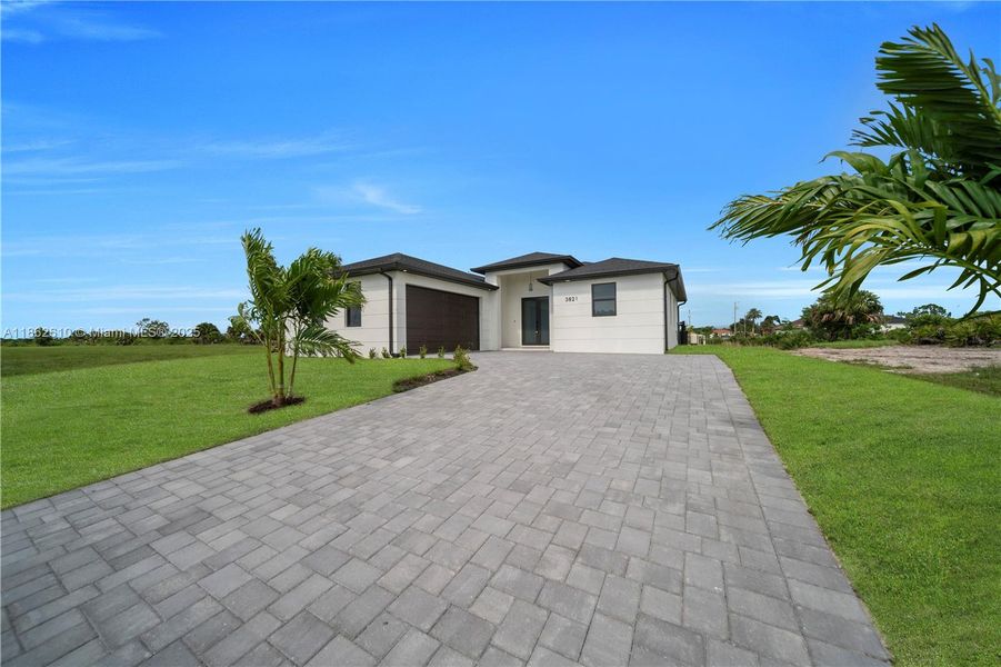Front exterior of a new home in , Cape Coral, FL, highlighting curb appeal (Image 1).