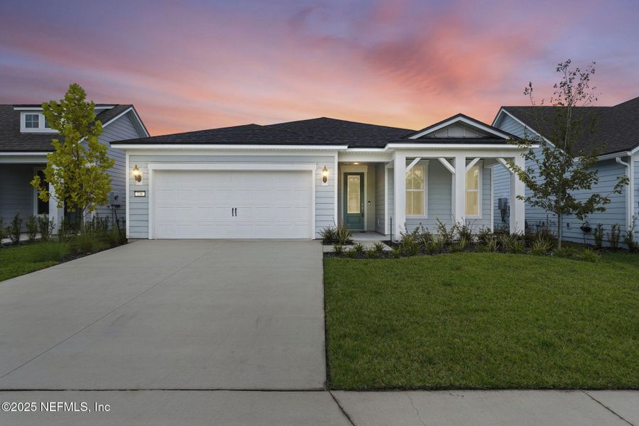 Front exterior of a new home in Summer Bay at Grand Oaks, St. Augustine, FL, highlighting curb appeal (Image 22).