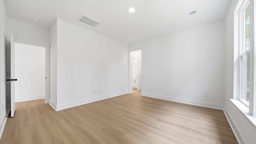 Eye-catching details and elegant finishes in the vibrant main level primary suite of this select home Eye-catching details and elegant finishes in the vibrant main level primary suite of this select home