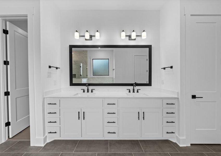 The gorgeous master bathroom has a giant vanity space that has two sinks and vanity space.