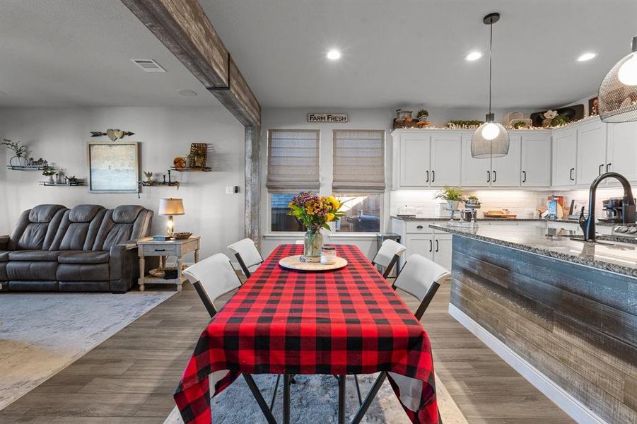 Dining space with wood-type flooring and sink