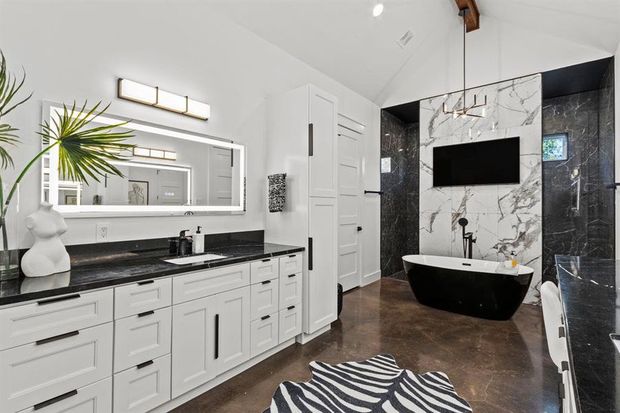 Luxurious lighted mirrors and ample lighting, plenty of cabinetry, and his and her closets just off the primary bathroom.