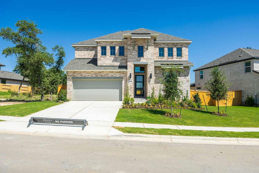 View of front facade with brick siding, concrete driveway, a garage, and roof with shingles View of front facade with brick siding, concrete driveway, a garage, and roof with shingles