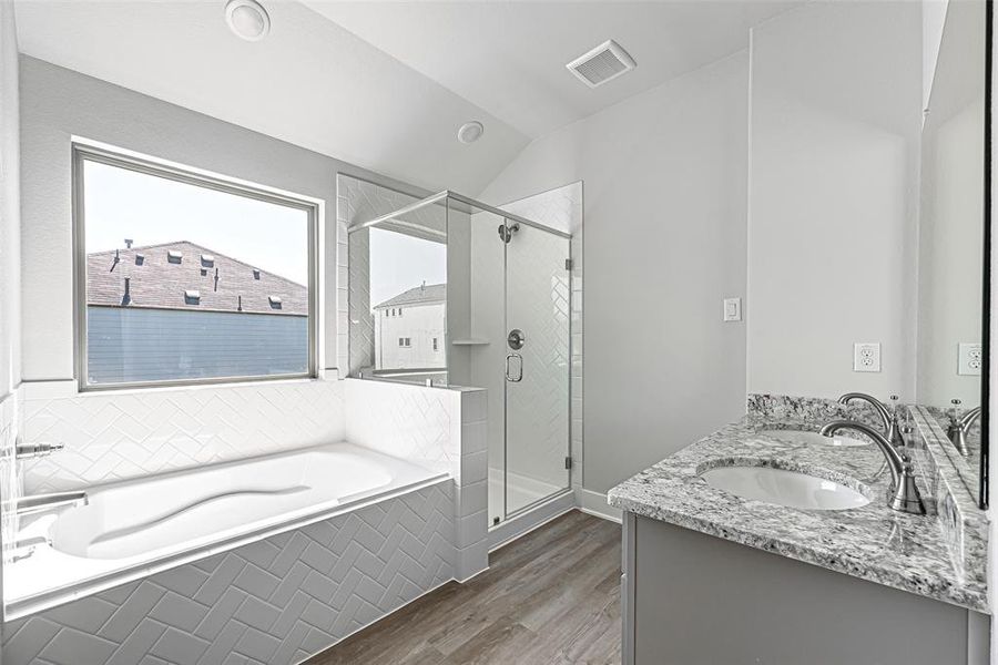 Primary Bath has a double vanity, soaking tub & walk in shower