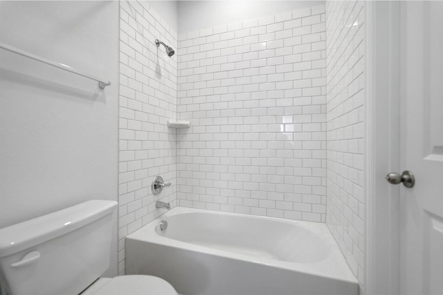 Full bath featuring toilet and shower / washtub combination