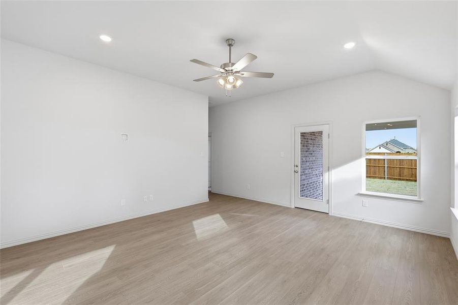 Spare room with light wood-style flooring, recessed lighting, a ceiling fan, and lofted ceiling