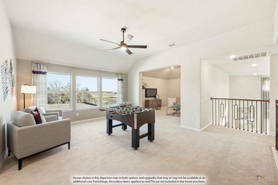 Upstairs game room with foosball table, ceiling fan, carpet, and open railing overlooking lower level