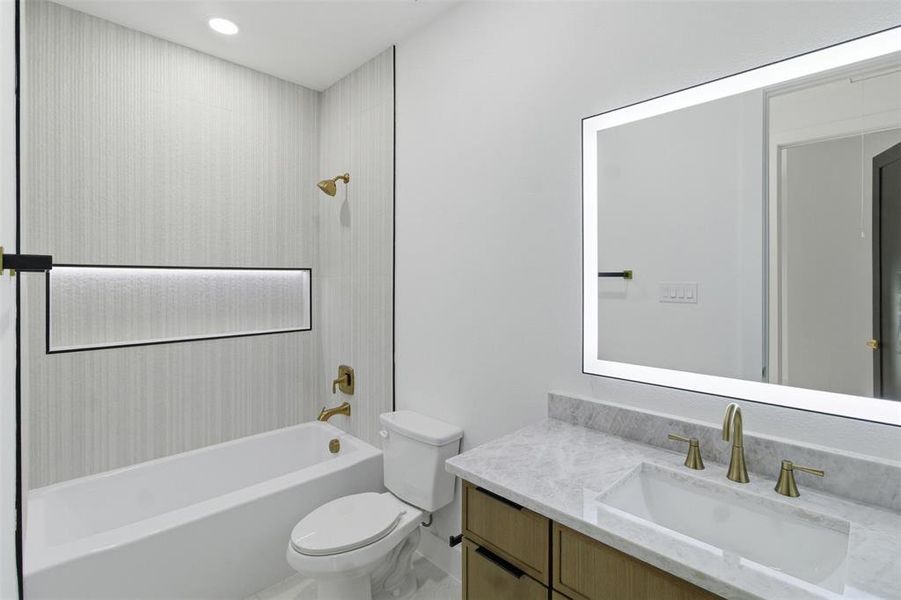 Full bathroom with shower / washtub combination and vanity