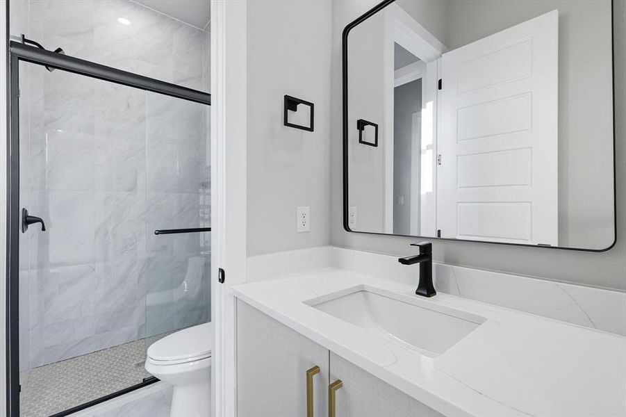 Bathroom with vanity and a marble finish shower Bathroom with vanity and a marble finish shower