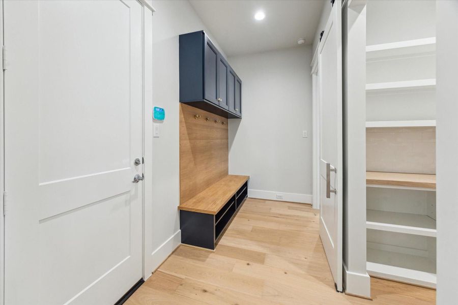 Downstairs mudroom off of the oversized garage with direct access to the pantry. Downstairs mudroom off of the oversized garage with direct access to the pantry.