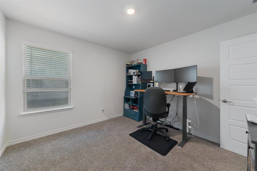 Home office featuring carpet flooring and baseboards