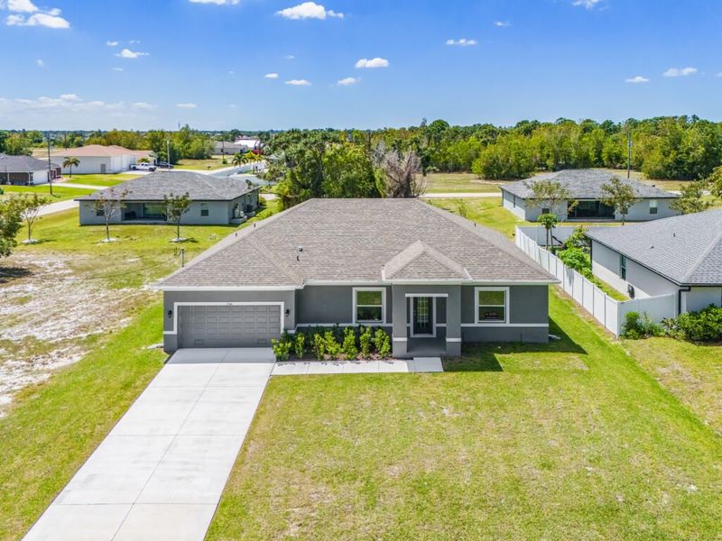 Front exterior of a new home in Cape Coral, Cape Coral, FL, highlighting curb appeal (Image 16). Front exterior of a new home in Cape Coral, Cape Coral, FL, highlighting curb appeal (Image 16).