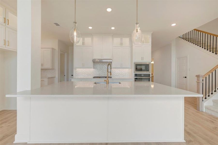 White kitchen island with a light-toned countertop