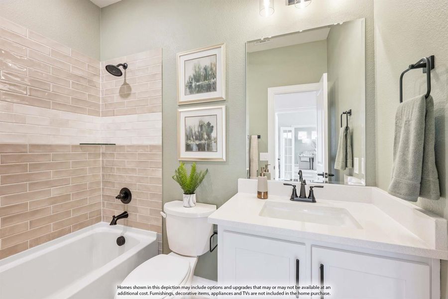 Bathroom with white vanity, soaking tub, beige subway tile surround, and matte black fixtures