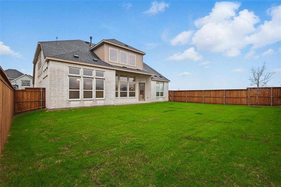 Back of property with brick siding and roof with shingles
