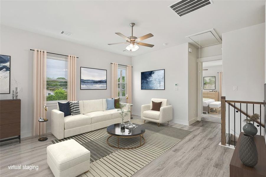 Living room featuring ceiling fan and light hardwood / wood-style flooring