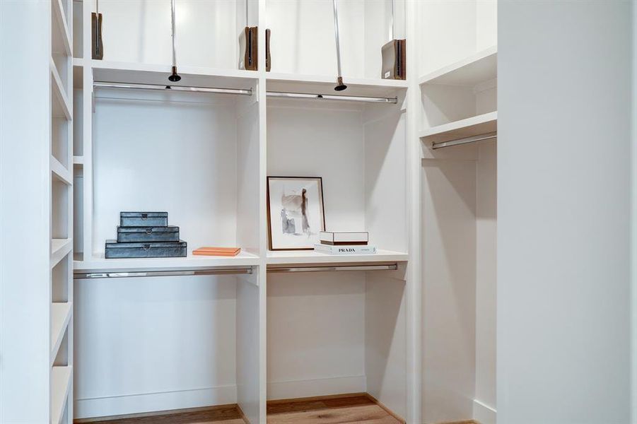 Photos are of 1502 A Ennis, the staged model at Linear on Bell. Choose from two design packages and floor plans. Expertly designed to maximize space, the closet contains pull downs, and built in shelving.