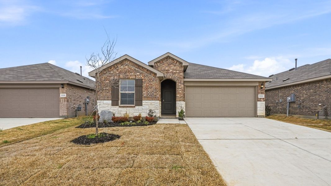 Front exterior of a new home in Legado, Cleburne, TX, highlighting curb appeal (Image 1). Front exterior of a new home in Legado, Cleburne, TX, highlighting curb appeal (Image 1).