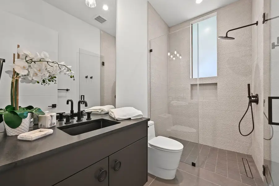 Full bathroom with vanity, walk in shower, and light tile patterned floors