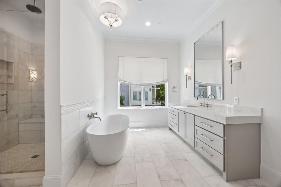 Custom Benedettini cabinetry, Kallista undermount sinks with Kallista fixtures, and elegant sconces complete this serene primary retreat.