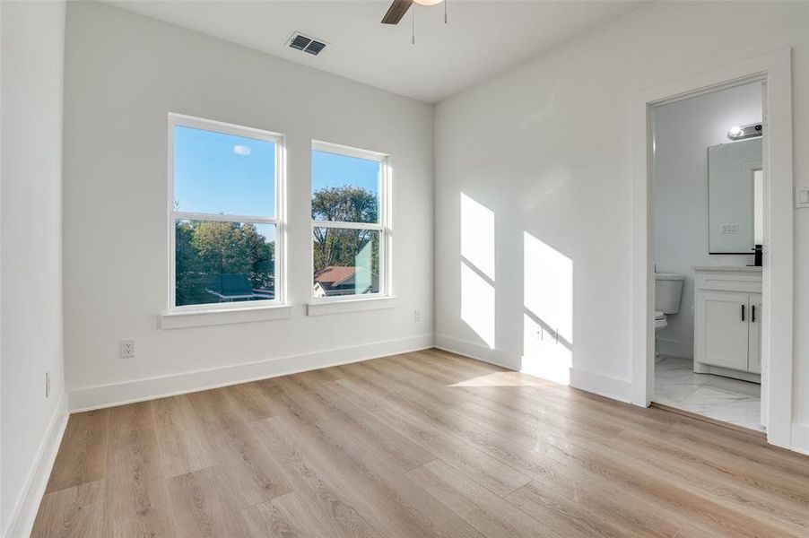 Empty room featuring ceiling fan and light wood-style floors