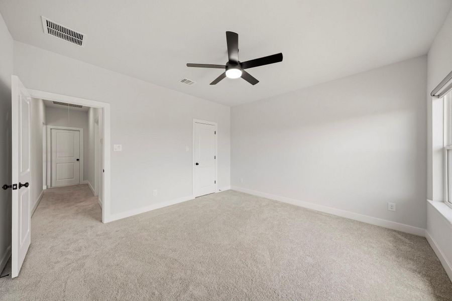 This private bedroom also features an ensuite bath through the door on the right.