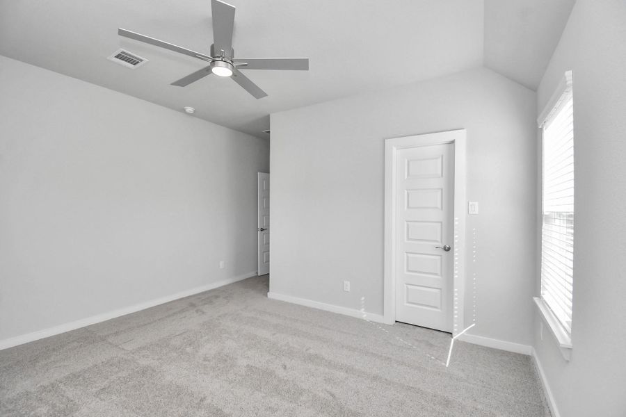 Secondary bedroom features plush carpeting, large windows that let in plenty of natural light, bright paint, and spacious closets.