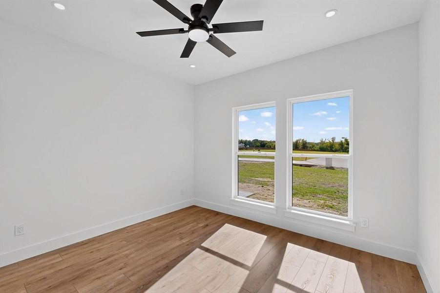 Spare room featuring light wood-type flooring, recessed lighting, and ceiling fan