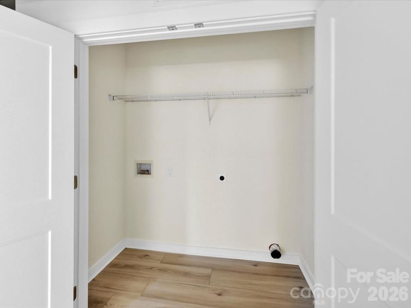 Dedicated laundry area with convenient washer and dryer hookups and built-in shelving for added storage. Dedicated laundry area with convenient washer and dryer hookups and built-in shelving for added storage.