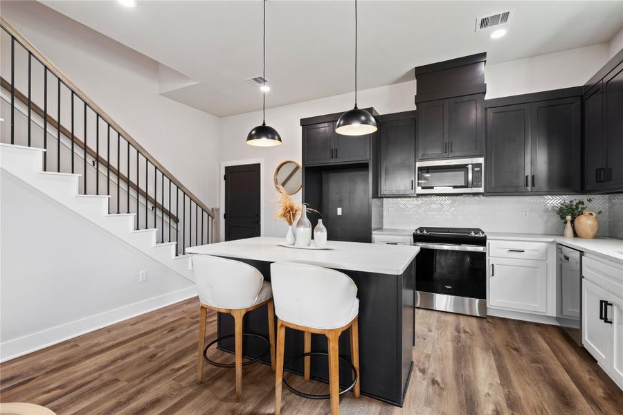 The dining and living areas flow together with a clean, open layout that feels both functional and elevated. With generous space and natural light throughout, this home is built to feel comfortable, welcoming, and easy to enjoy.