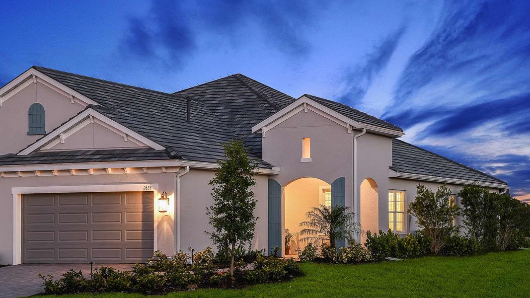 Front exterior of a new home in Windward, Lakewood Ranch, FL, highlighting curb appeal (Image 16). Front exterior of a new home in Windward, Lakewood Ranch, FL, highlighting curb appeal (Image 16).