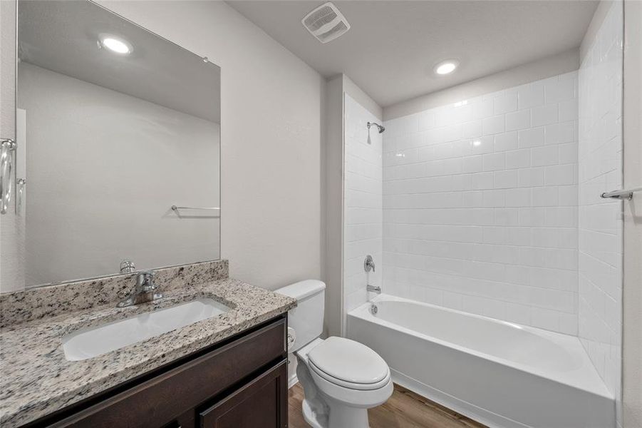 Bathroom with wood finished floors, vanity, shower combination, and recessed lighting Bathroom with wood finished floors, vanity, shower combination, and recessed lighting