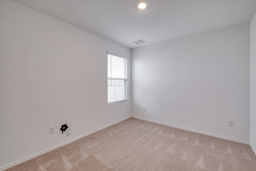 Carpeted room featuring a single window with blinds, recessed ceiling lighting, and white walls