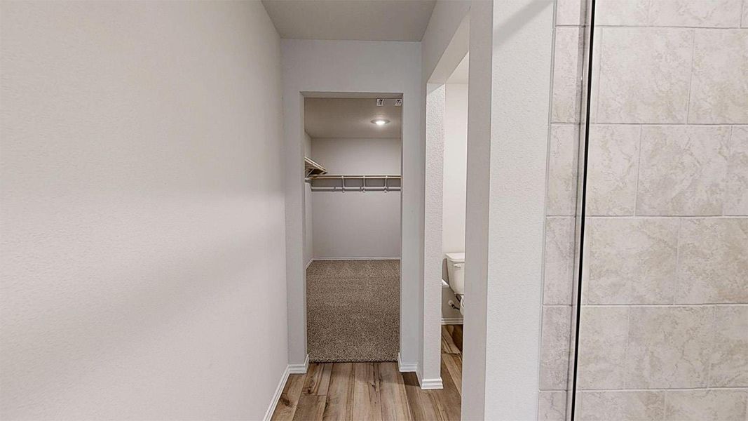 Corridor with baseboards and light wood-style flooring