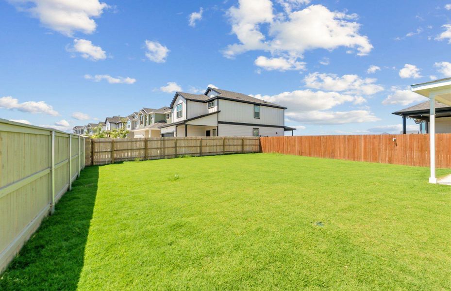 Front exterior of a new home in Santa Rita Ranch, Liberty Hill, TX, highlighting curb appeal (Image 1). Front exterior of a new home in Santa Rita Ranch, Liberty Hill, TX, highlighting curb appeal (Image 1).