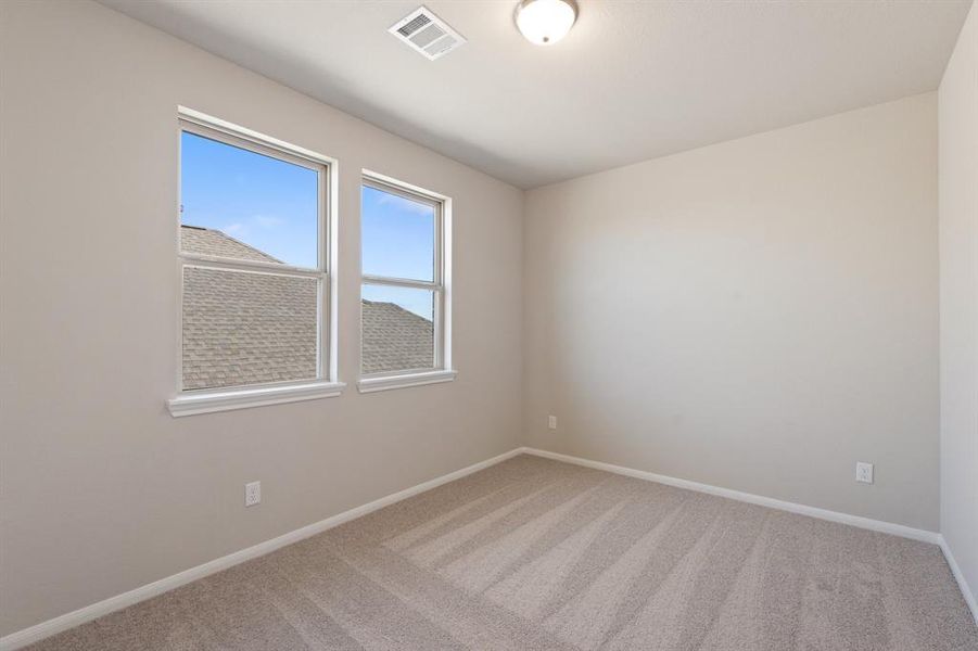 Your secondary bedroom features plush carpet, fresh paint, closet, and a large window that lets in plenty of natural lighting.