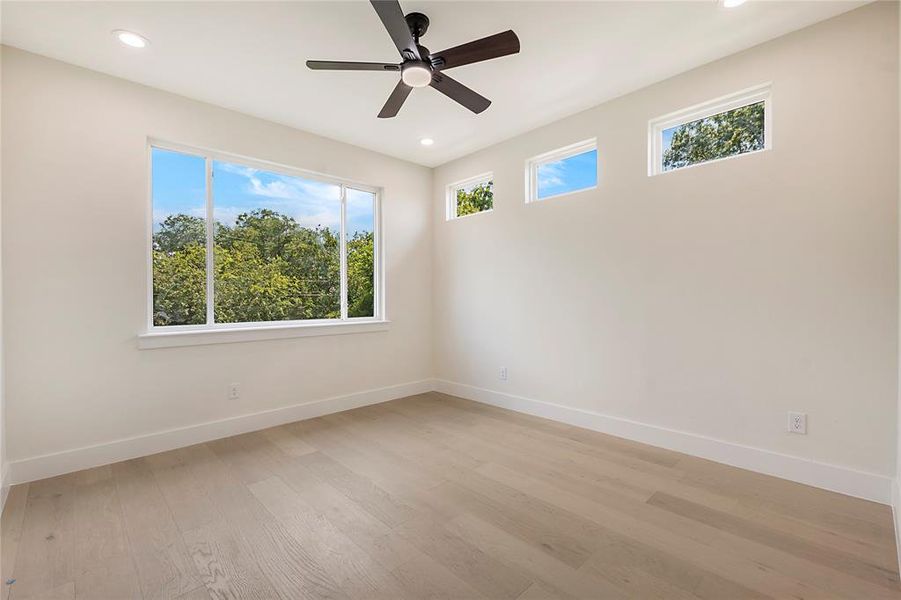 Spare room with light hardwood / wood-style flooring and ceiling fan