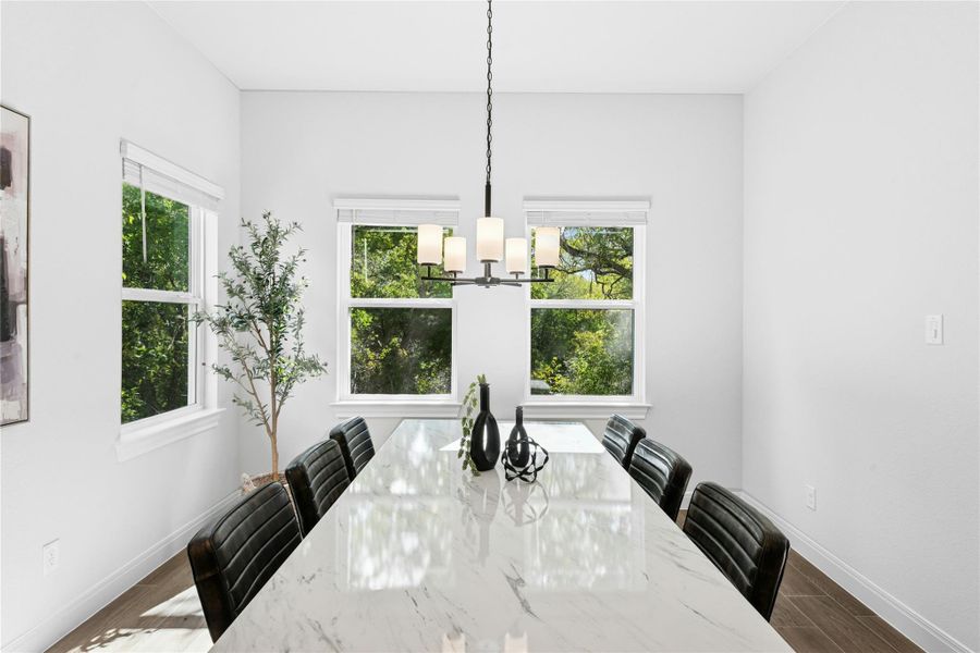Dining area featuring plenty of natural light and chandeleir Dining area featuring plenty of natural light and chandeleir
