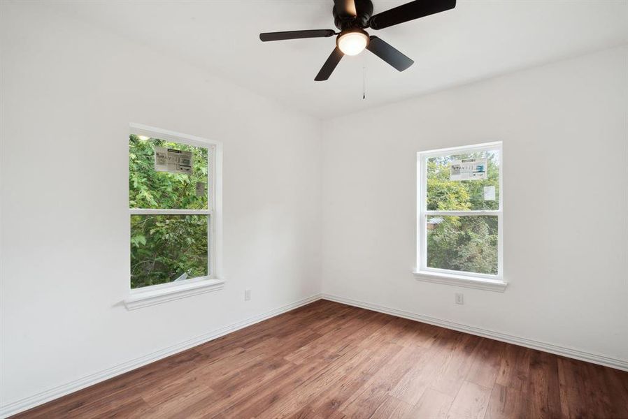 Empty room featuring hardwood / wood-style floors and ceiling fan