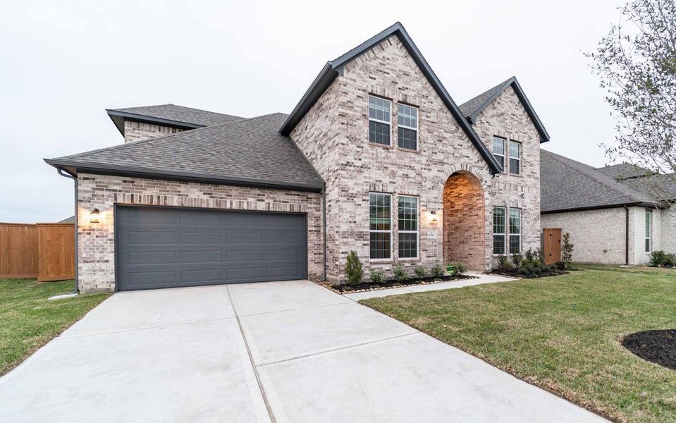 Front exterior of a new home in Marvida, Cypress, TX, highlighting curb appeal (Image 18). Front exterior of a new home in Marvida, Cypress, TX, highlighting curb appeal (Image 18).