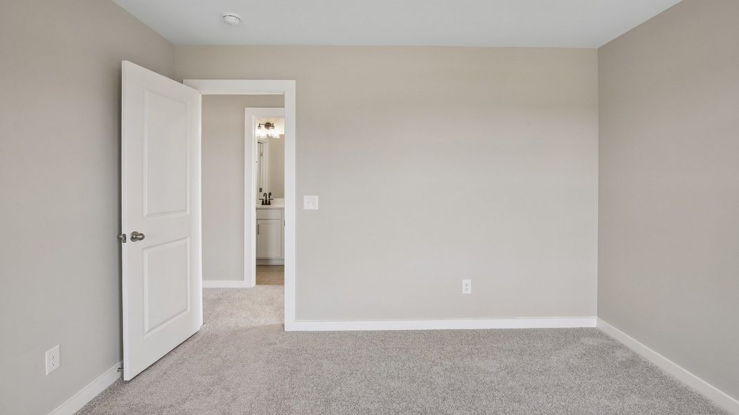 Bedroom with walk-in closet and window